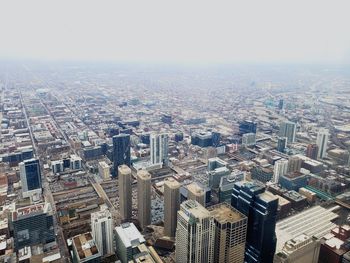 High angle view of modern buildings in city against sky