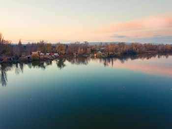 Scenic view of lake against sky during sunset