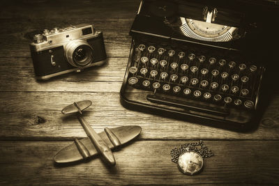Close-up of camera and typewriter on table