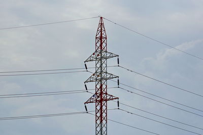 Low angle view of electricity pylon against sky