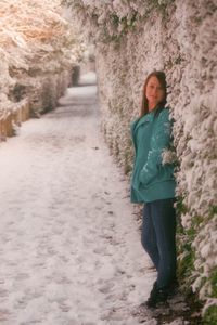 Full length of woman standing in snow