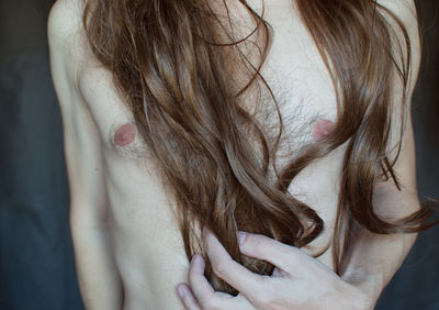 Midsection of man with long hair