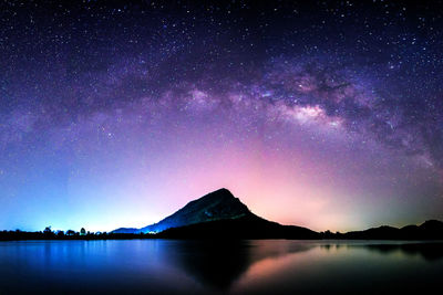 Scenic view of lake against sky at night