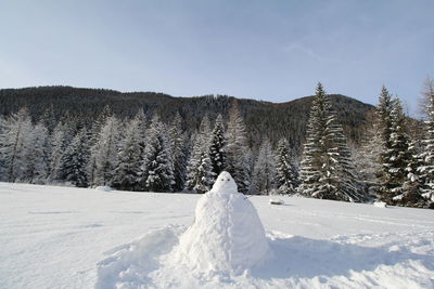 Snow covered landscape against sky