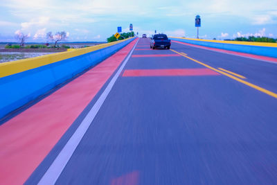 Cars on road against sky