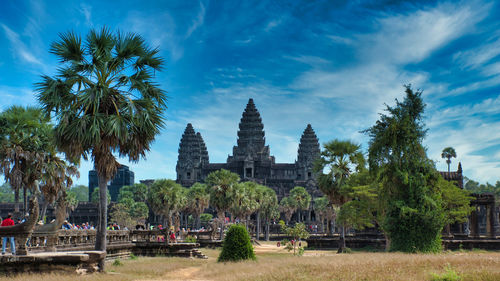 View of trees and temple against sky