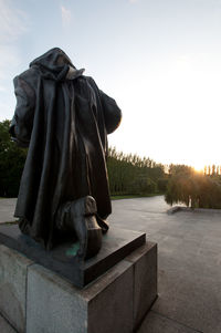 Statue against clear sky during sunset