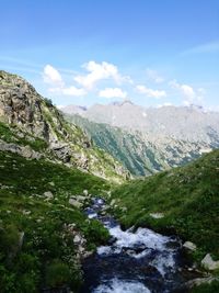 Scenic view of waterfall against sky