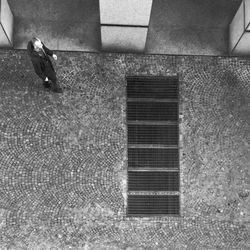 Man seen through metal grate