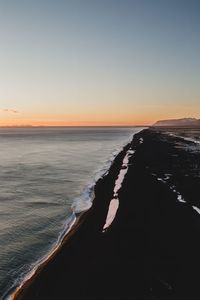 Scenic view of sea against clear sky during sunset