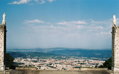 High angle view of townscape by sea against sky