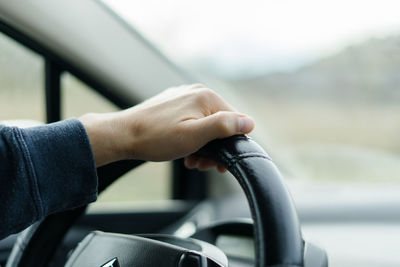 Midsection of man driving car