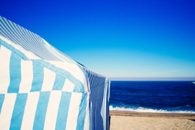 Blue tent at beach against sky