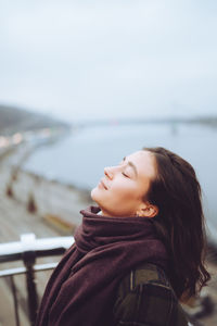 Portrait of young woman with scarf on the city street