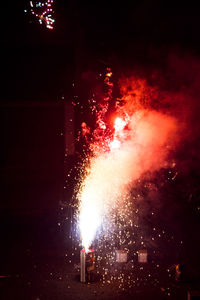 Close-up of illuminated fire against sky