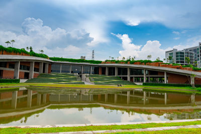 Reflection of building in lake against sky