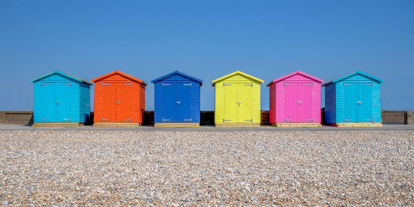 Beach huts against blue sky