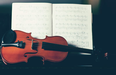 Close-up of violin on sheet music