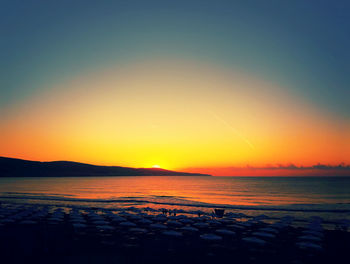 Scenic view of sea against clear sky during sunset