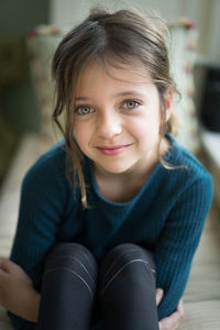 Portrait of smiling girl sitting outdoors