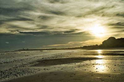 Scenic view of beach against sky during sunset