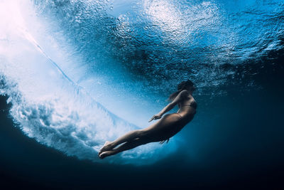 Low section of woman swimming in sea