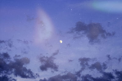 Low angle view of moon in sky at night