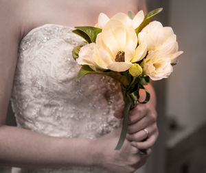 Close-up of hand holding rose