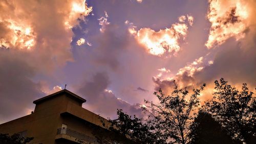 Low angle view of building against sky at sunset