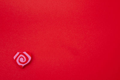 Close-up of heart shape on red wall