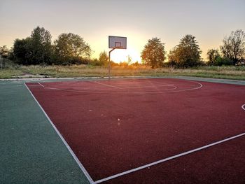 View of basketball hoop against sky during sunset