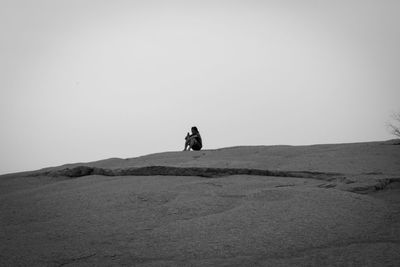 Man standing on land against clear sky