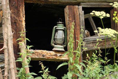 View of old abandoned building and old lantern on the window