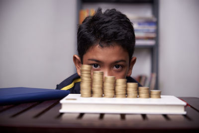 Portrait of boy with toy on table