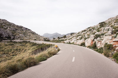 Road amidst mountains against sky