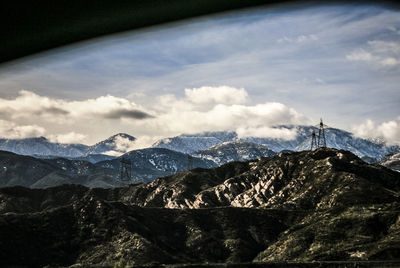 Scenic view of mountains against cloudy sky