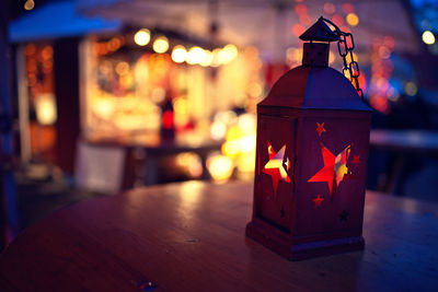 Close-up of illuminated lantern on table
