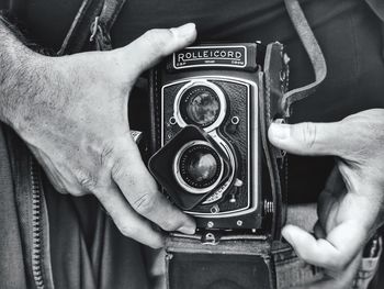 Midsection of man photographing with camera