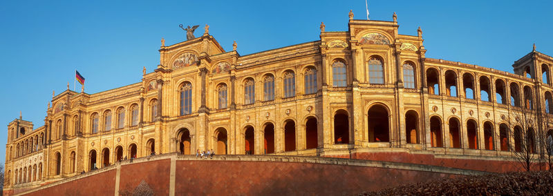 Low angle view of historical building against blue sky