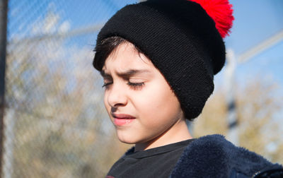 Close up portrait of child wearing warm clothing