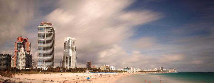 View of cityscape against cloudy sky