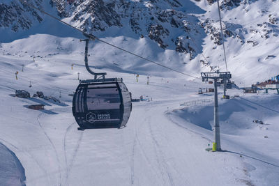 Ski lift over snow covered mountains