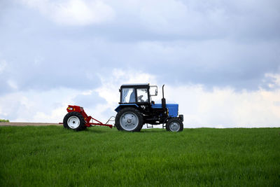 Tractor on field against sky