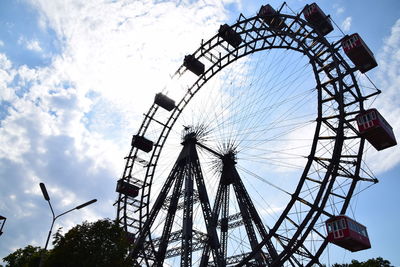 Low angle view of amusement park against sky