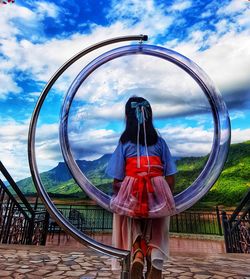 Woman standing against sky