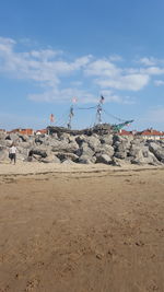 Group of people on rock against sky