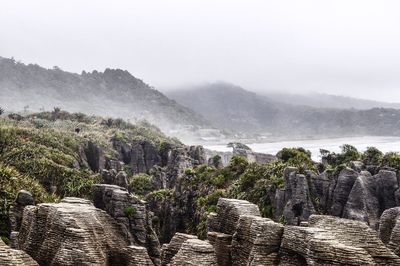 Scenic view of rock formations and mountains against sky