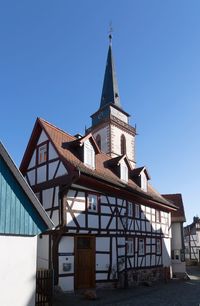 Low angle view of building against clear blue sky