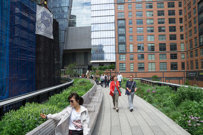 People walking on sidewalk in city