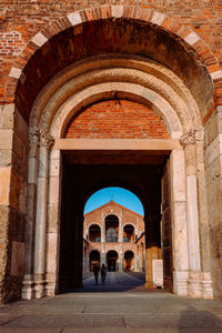 Entrance of the basilica of sant'ambrogio with people, vertical